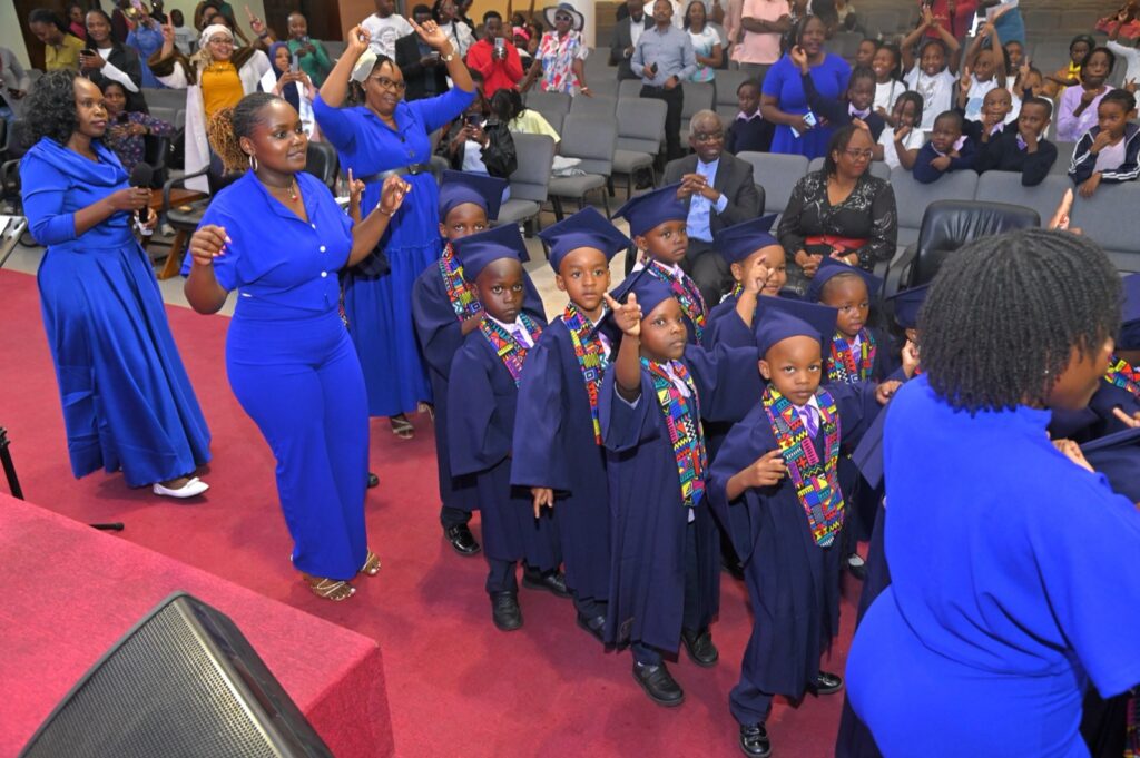 Teachers leading PP2 graduates to the stage