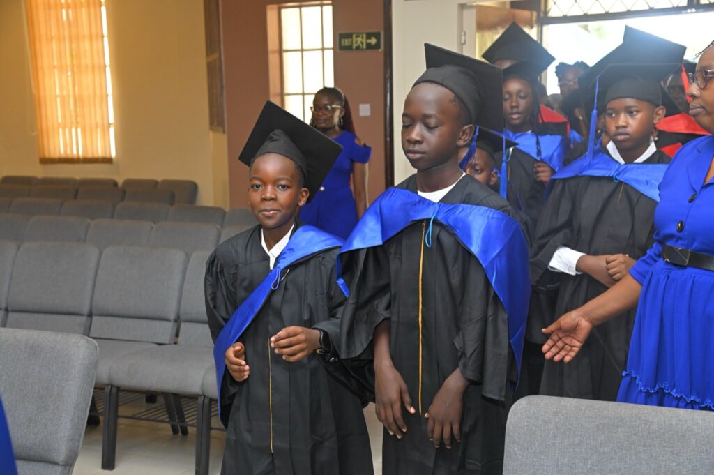 Grade 9 graduates in black gowns walking in