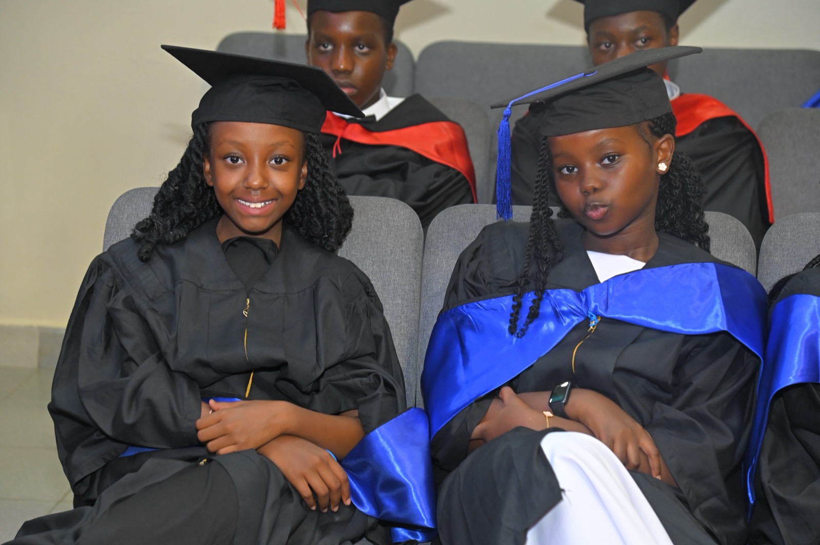 Grade 9 graduates seated in caps and gowns
