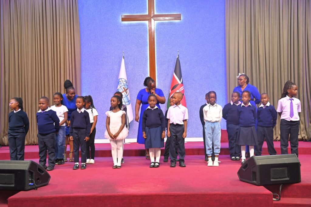 A class performing on stage at the graduation