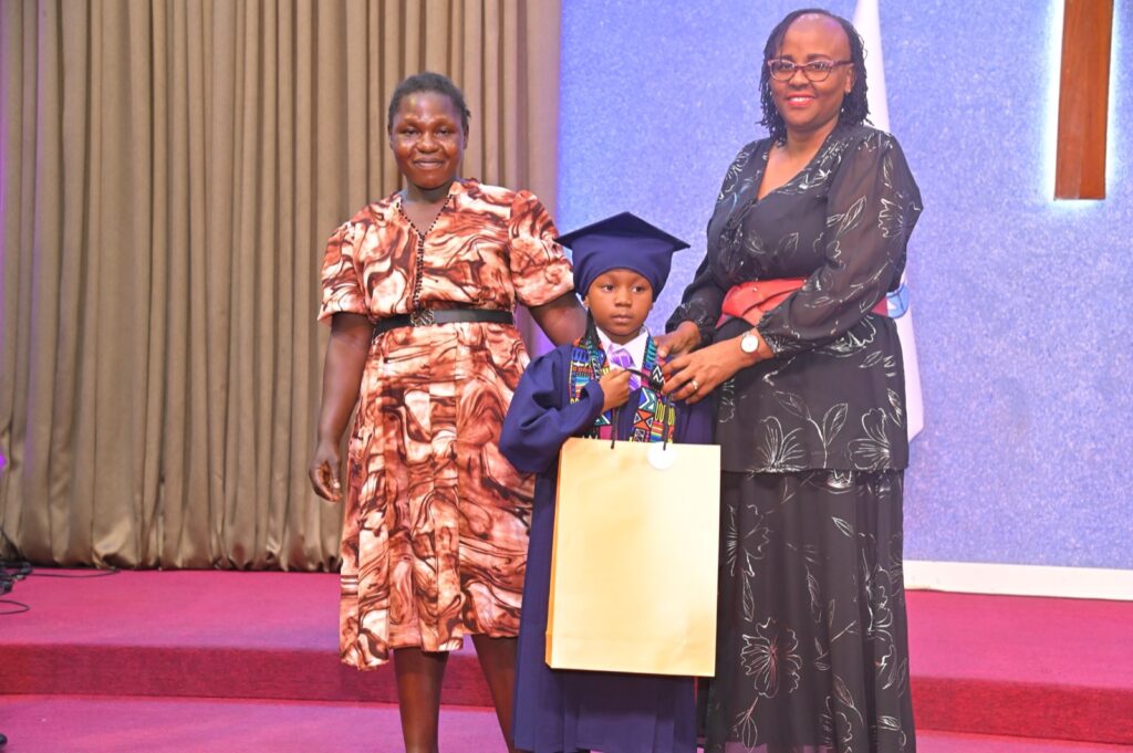A PP2 graduate receiving a certificate and gift