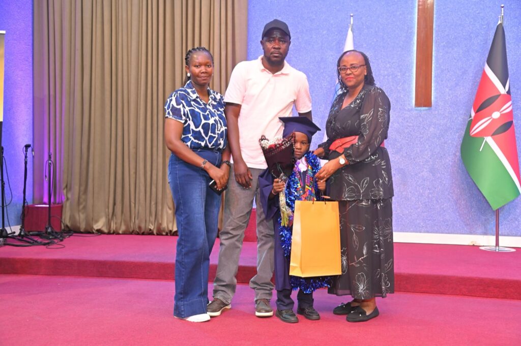 A family celebrating with their graduate on stage