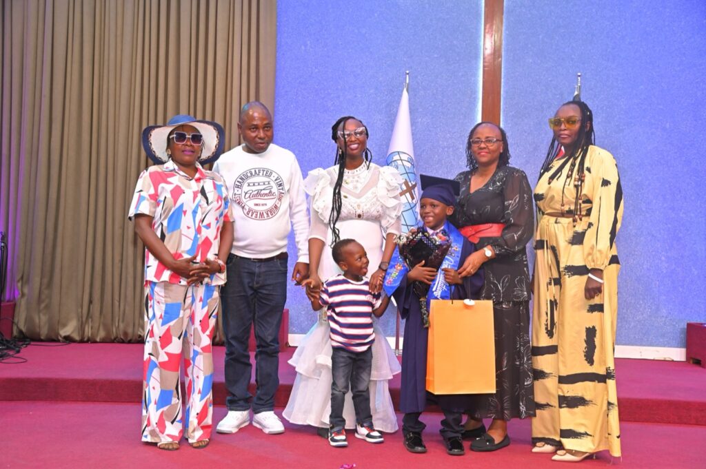 Family and graduate with the school head at the certificate presentation