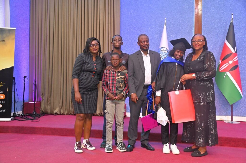 A Grade 9 graduate with family at the certificate presentation