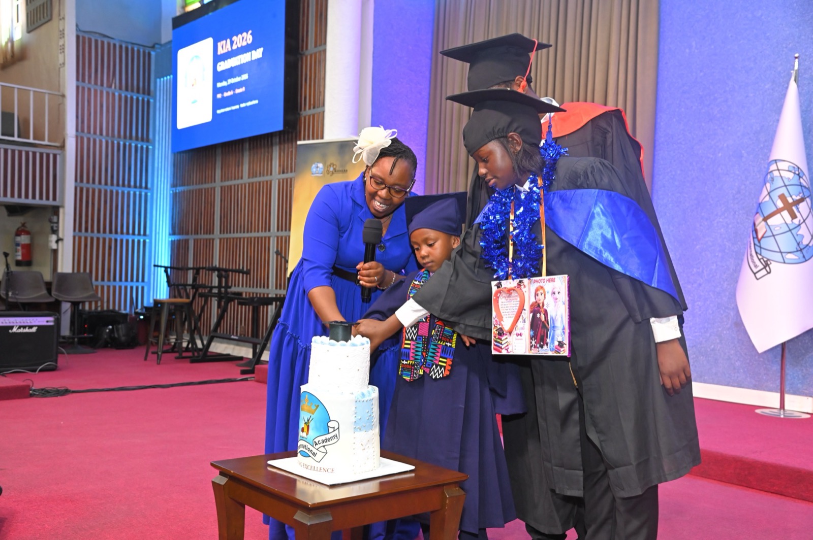 Graduates cutting the graduation cake