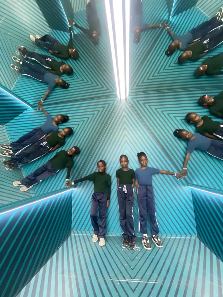 Lower Primary learners inside an illusion room at the Museum of Illusions