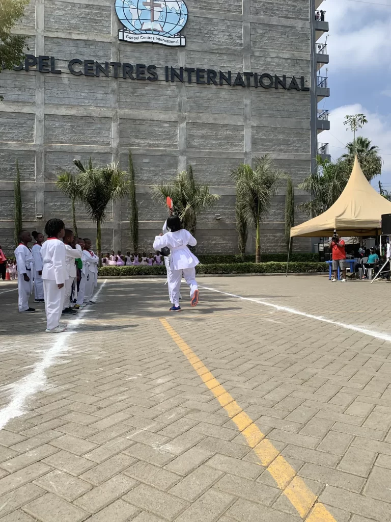 Learners in martial arts uniforms performing at Kings International Academy Sports Day 2026